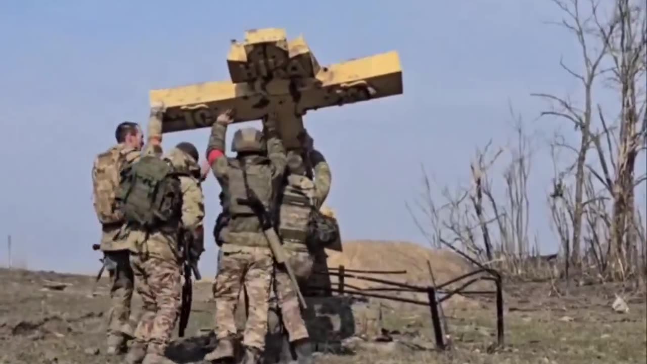 Russian soldiers restore a Cross in the Kursk Oblast