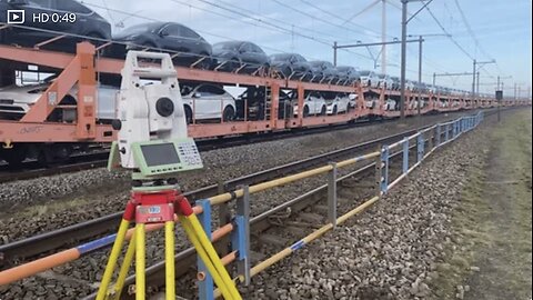 METEREN, NL - Jan 31, 2025: A Train with new Tesla cars driving past while mea