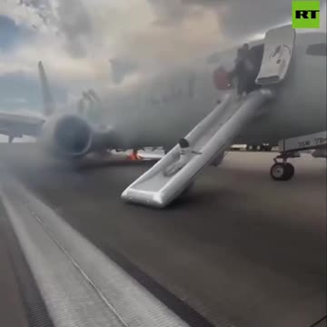 PANIC on runway as wheel of American Airlines plane catches FIRE