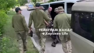 solemn delivery of a volunteer's body to the bus with a bicycle in Kharkiv.