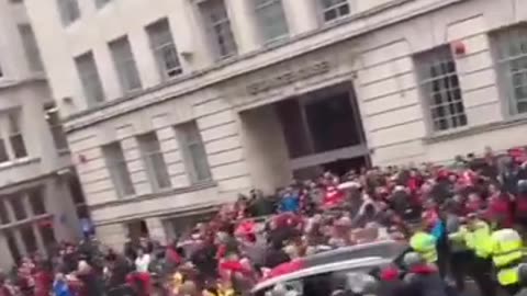 A car drives straight through the crowd at Liverpool’s Premier League winning parade