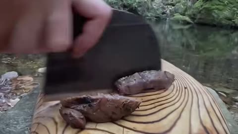 Veal pearls grilled in the primitive way in the forest