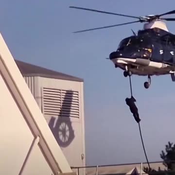 Mask figures drop from helicopter near Manchester Tescos