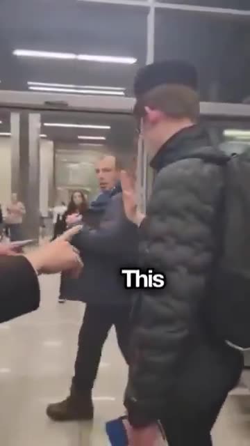 A Polish airport worker is seen confronting a visibly Jewish man, stepping into his space