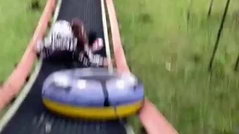 Girl Falls from Slide as Tube's Cord Snags on Rail