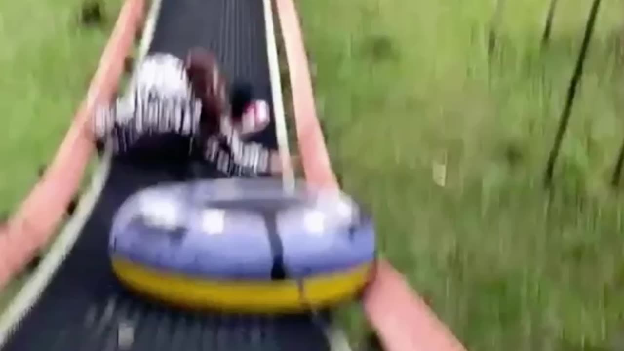 Girl Falls from Slide as Tube's Cord Snags on Rail