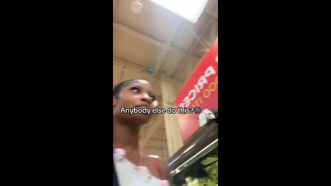 Joseph Martelli Niagara Falls, NY Woman takes a carrot off of the shelf at Walmart in the produce