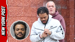 Jawarren Booker, facing first-degree rape and burglary charges, is escorted out of a Suffolk Co. precinct