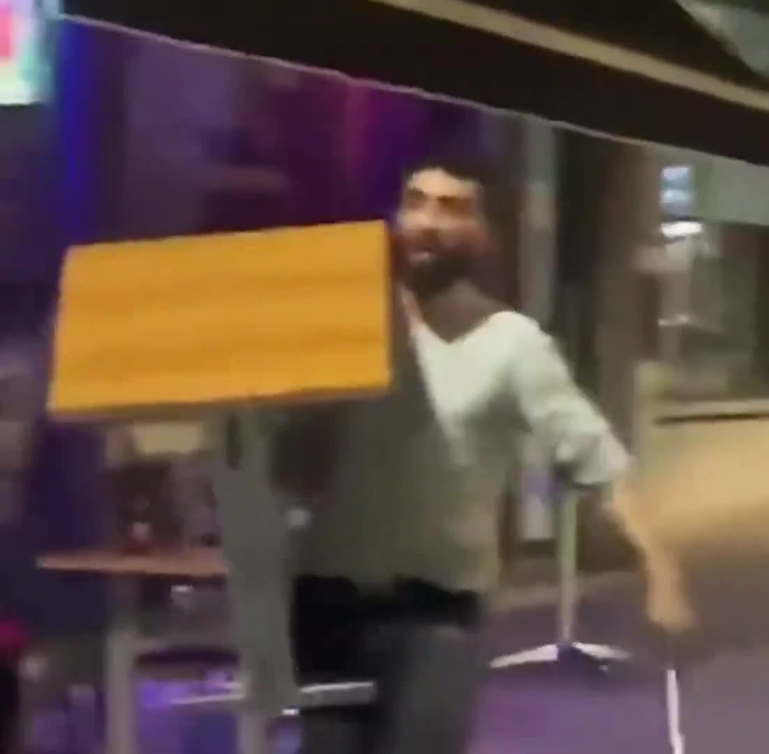 In Belgium, an antisocial refugee named Mohammed threatens a man with a machete...