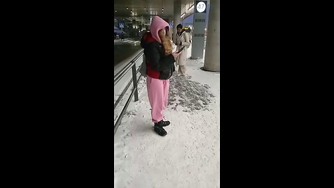 Girl freezes while waiting for the bus.