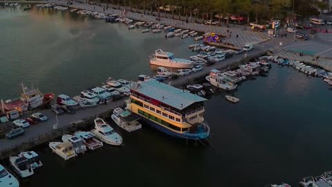 The beauty of the sunset on the seashore with the view of rows of boats