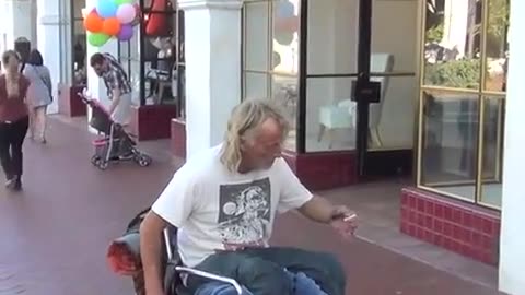 Guy tries to public prank the coolest Jesus-looking street dude..