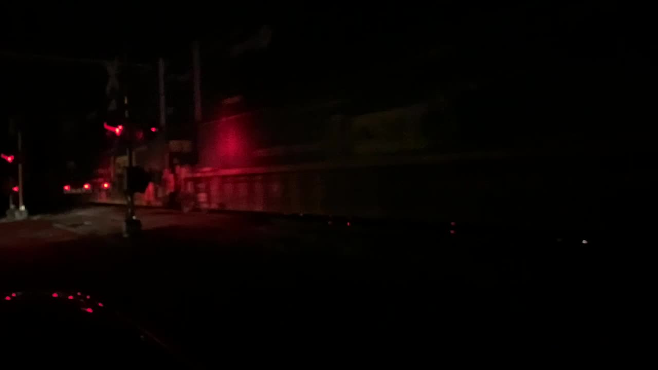 CSX Train meet at night with a light coming out of the darkness