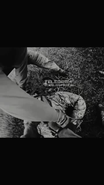 Ukrainian Soldiers Prepare Russian POW for Transport While Searching Another