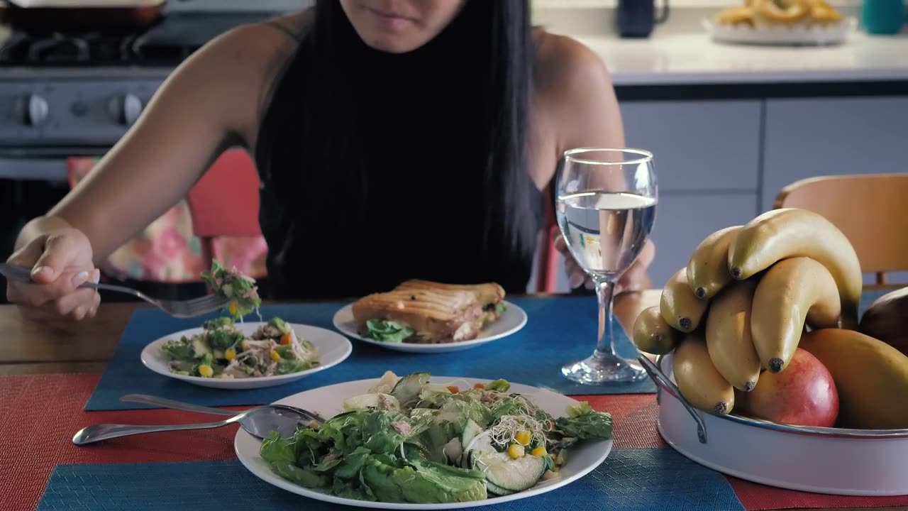 Young woman eating salad.