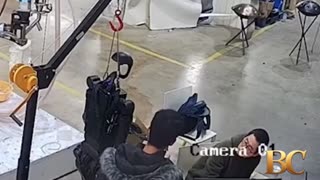 Haunting moment robot attacks handlers in angry rampage as it tries to break free from restraints