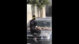 a person attacking the Israeli army with a stone