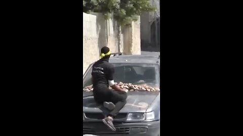 a person attacking the Israeli army with a stone