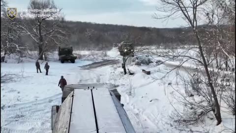 Ukrainian combat engineers are creating a pontoon bridge for logistical supplies