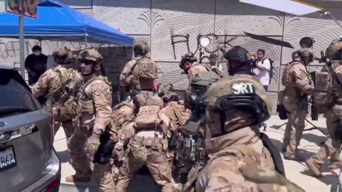 DHS agents swarm a rioter who threw an object at them.