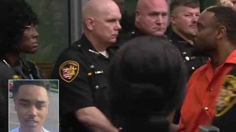 Father who killed police officer days after police shot his 18-year-old son walks past 30 officers.