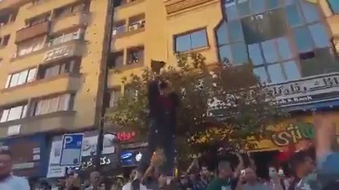 A brave woman in Iran publicly removes her hijab