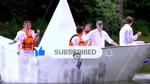 7 people are sitting on a paper boat