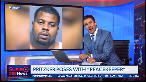 PRITZKER POSES WITH PEACEKEEPER
