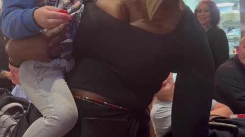 Waitress Comforts Crying Toddler While Serving Tables