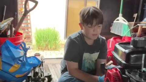 Justus does more work on the pressure washer