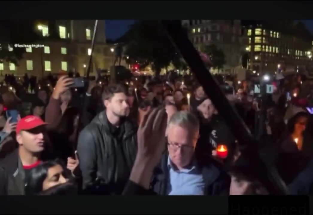 Huge crowds gather at Winston Churchill statue in London, candles lit, honoring Charlie Kirk’s life.