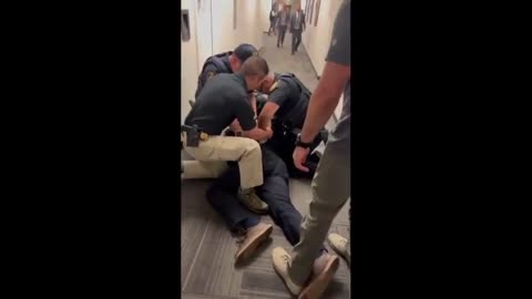 Police officers put Senator Alex Padilla on the ground