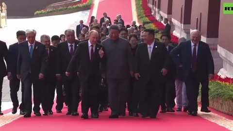 Putin, Xi Jinping and Kim Jong Un share a moment on the way to their seats