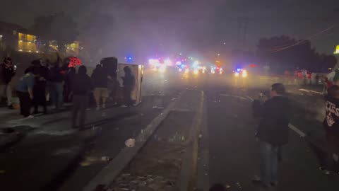 The scene in LA is escalating quickly. More and more fires are lit, a tractor trailer is broken into