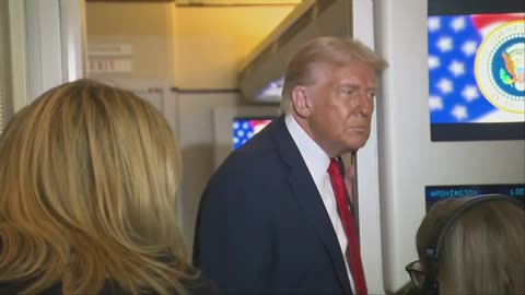 President Trump speaks with reporters aboard Air Force One