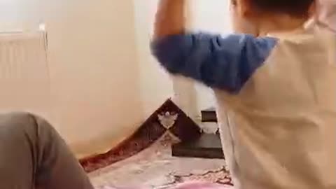Cute Radmehr's son plays with a piece of tissue paper and laughs