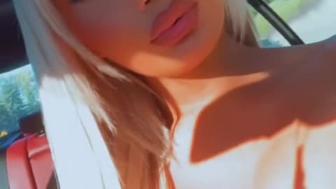 A doll tgirl inside the car