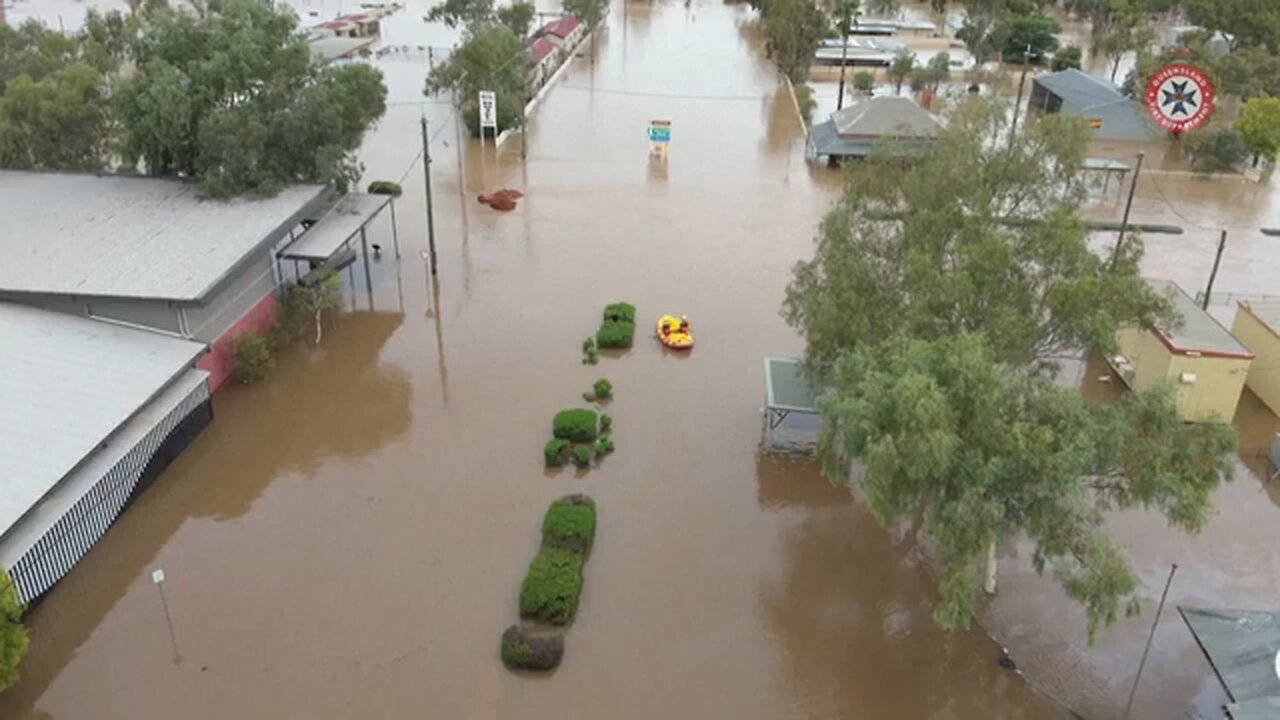 Emergency crew work in flood water as outback Australia drenched