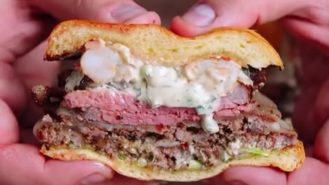 burger with bunch of meats loaded.Double patty and cheese, lobster and a tender steak.