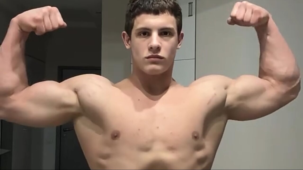 18 years old bodybuilder flexing muscles