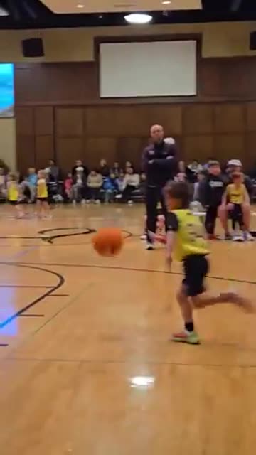 A coach blocks an opposing teams shot.