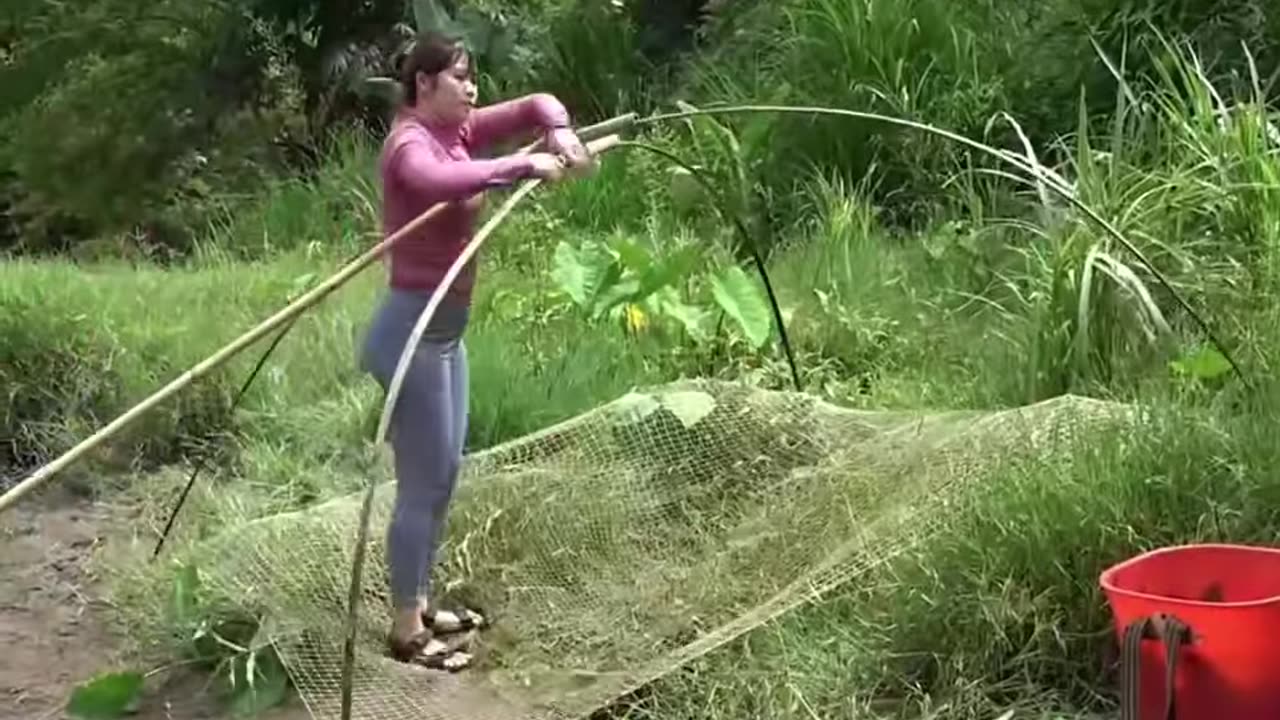 Village girl catching fish from river