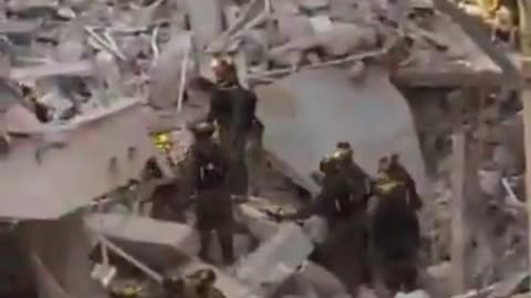 Footage shows Israeli rescue teams searching for survivors trapped under rubble in Bat Ya
