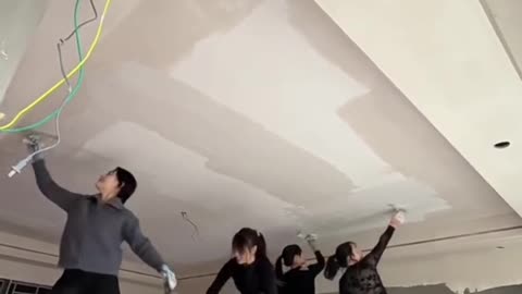 Energetic Girls Plastering a Ceiling