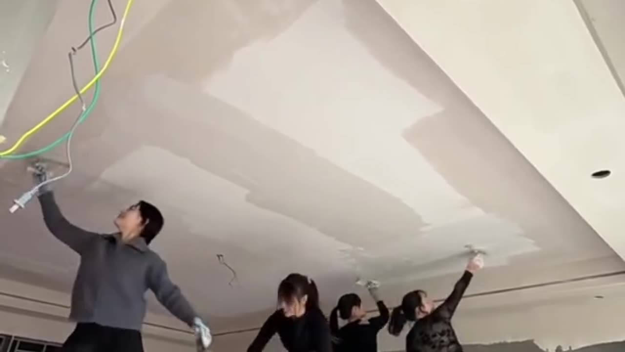 Energetic Girls Plastering a Ceiling