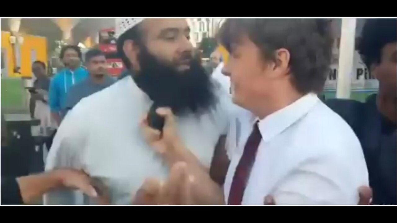 Young Christian street preacher aggressively confronted by a group of Muslims in London.