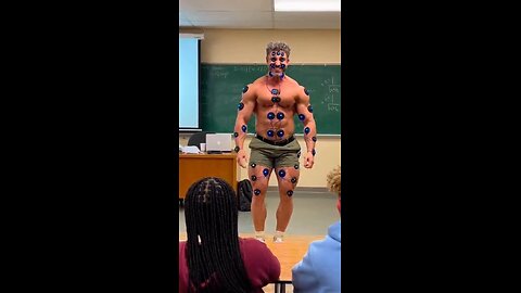 Joseph Martelli College professor using electric muscle stimulator to teach how to use them