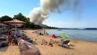 Beach-goers watch as wildfire burns in Greece's Halkidiki