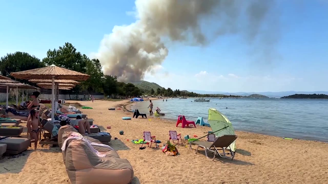 Beach-goers watch as wildfire burns in Greece's Halkidiki