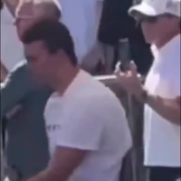 2 men standing behind Charlie Kirk look like they gave hand signals right before the shot went off